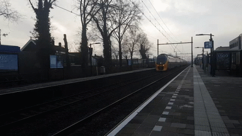 A Train Is Pulling Into A Station With A Sign That Says 3500 On It GIF