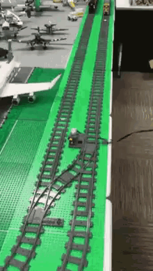 A Train Track Made Out Of Lego Is On A Table . GIF