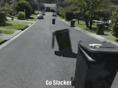 A Trash Can Is Flying Through The Air On The Side Of A Street . GIF