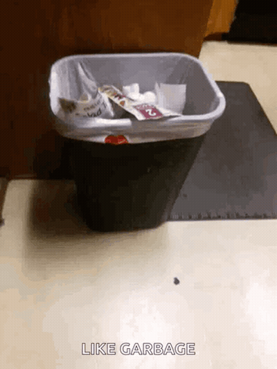 A Trash Can Is Sitting On The Floor With The Words Like Garbage Above It GIF