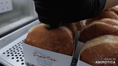A Tray Of Doughnuts With A Label That Says Made In Animotica GIF