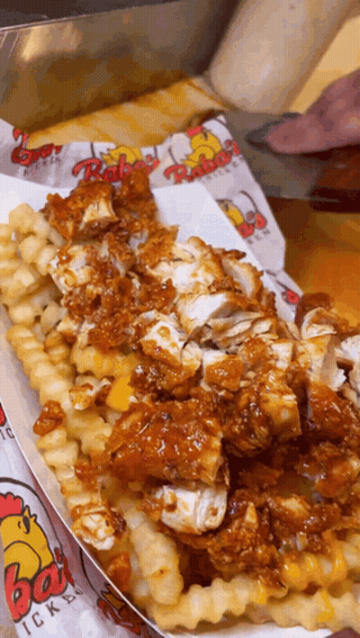 A Tray Of Fried Chicken And French Fries With Rubes Chicken Printed On It GIF