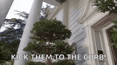 A Tree In Front Of A White House With The Words `` Kick Them To The Curb '' Written On It . GIF