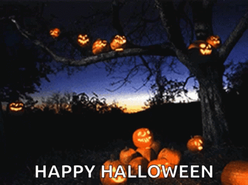 A Tree With Pumpkins Hanging From It And The Words Happy Halloween GIF