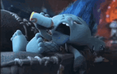 A Troll Is Drinking Milk From A Bottle While Laying Down . GIF
