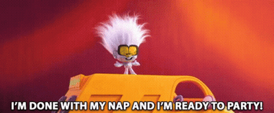 A Troll Is Sitting On Top Of A Yellow Vehicle With The Words I M Done With My Nap And I 'M Ready To Party GIF