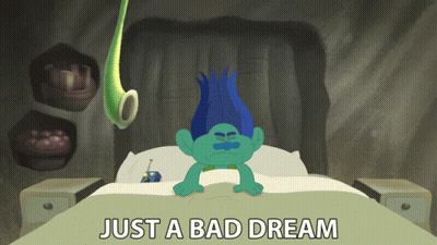 A Troll Laying On A Bed With The Words Just A Bad Dream Above Him GIF