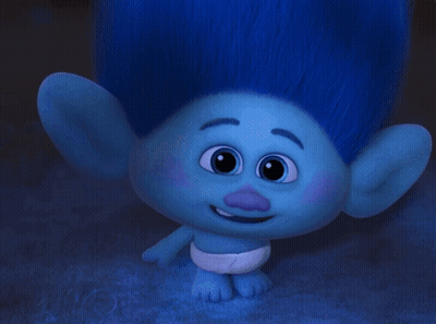 A Troll Wearing Glasses And A Diaper Looks At The Camera GIF