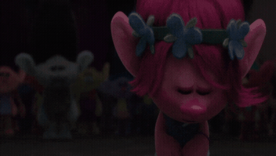 A Troll With Pink Hair And Blue Flowers On It GIF