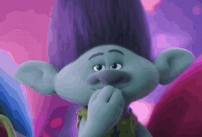 A Troll With Purple Hair Is Covering His Mouth GIF