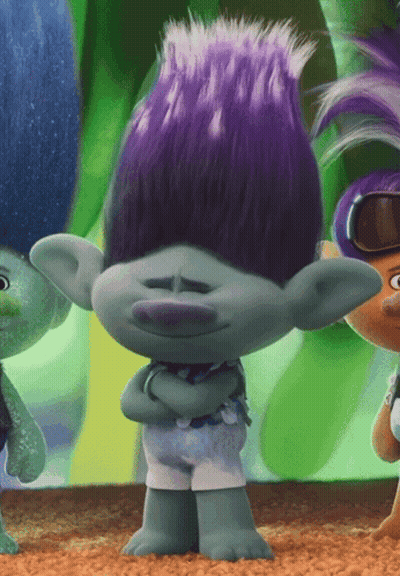 A Troll With Purple Hair Is Standing With His Arms Folded GIF