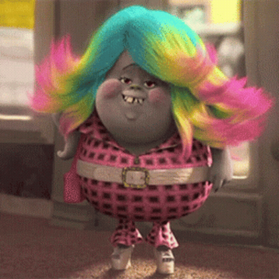A Troll With Rainbow Hair Is Wearing A Pink Plaid Outfit GIF