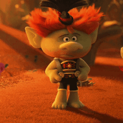 A Troll With Red Hair And A Top Hat Is Standing In The Desert GIF