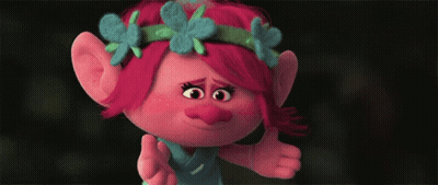 A Troll With Red Hair And Blue Flowers On Her Head Giving A Thumbs Up GIF