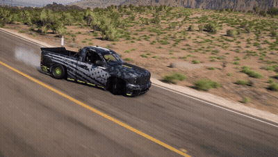 A Truck Is Driving Down A Desert Road With Smoke Coming Out Of The Tires GIF