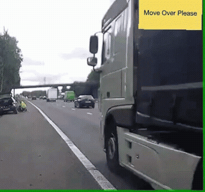 A Truck Is Driving Down A Highway And A Yellow Sign Says Move Over Please GIF