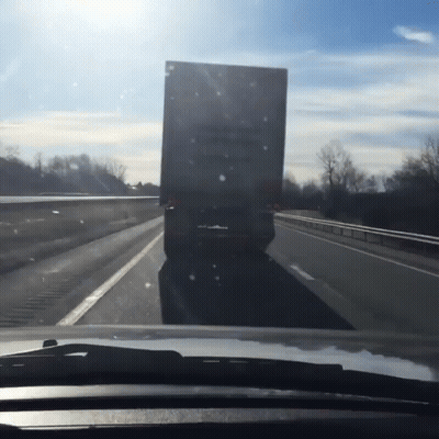 A Truck Is Driving Down A Highway With A Sign On The Back That Says ' A ' On It GIF