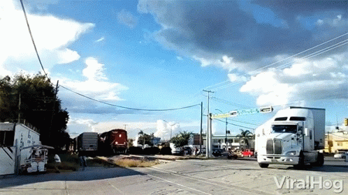 A Truck Is Driving Down A Road Next To A Train With The Words Viralhog Written On The Bottom GIF