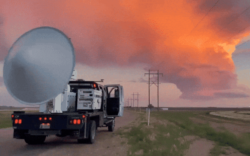 A Truck Is Parked On The Side Of A Dirt Road With A Sunset In The Background And The License Plate Says Nc GIF