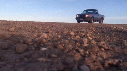 A Truck On A Dirt Road With A License Plate That Says ' Aa ' On It GIF