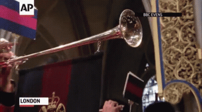 A Trumpet Is Being Played In Front Of A Flag That Says Ap On It GIF