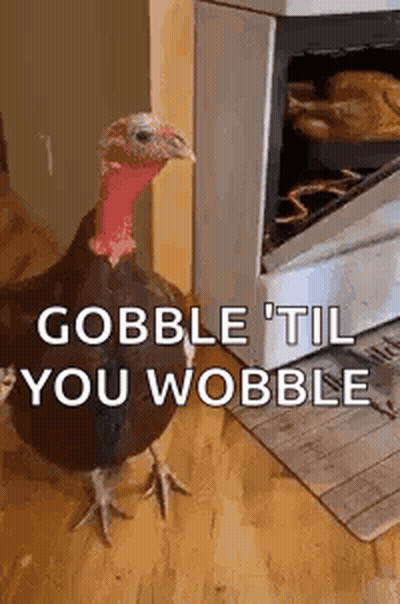 A Turkey Is Standing In Front Of An Oven And Says `` Gobble Til You Wobble '' . GIF