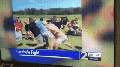 A Tv Screen Shows A Cornhole Fight On The News Channel GIF
