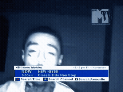 A Tv Screen Shows A Young Boy And Says " New Hits " On It GIF