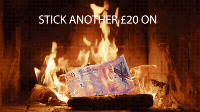 A Twenty Pound Bill Is Burning In A Fireplace GIF