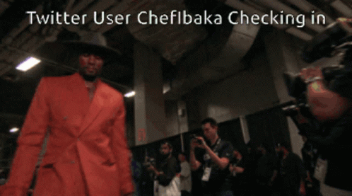 A Twitter User Named Chefibaka Checking In With A Picture Of A Man In An Orange Suit GIF