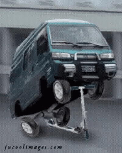 A Van Is Sitting On Top Of A Scooter With Jucoolimages.com Written On The Bottom GIF