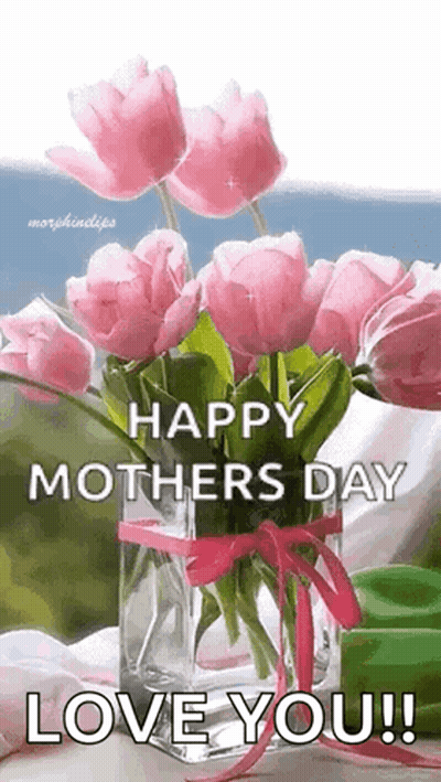 A Vase Filled With Pink Flowers Is Sitting On A Table . GIF