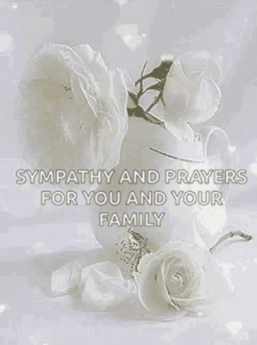 A Vase Of Flowers With The Words `` Sympathy And Prayers For You And Your Family '' On It . GIF