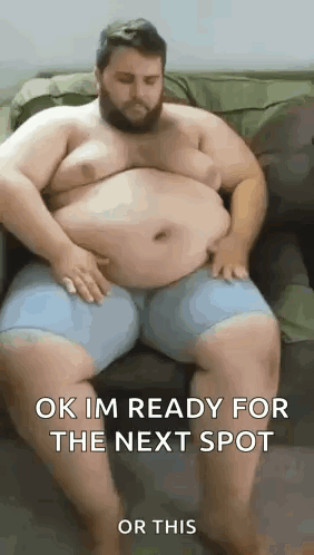 A Very Fat Man Is Sitting On A Couch . GIF