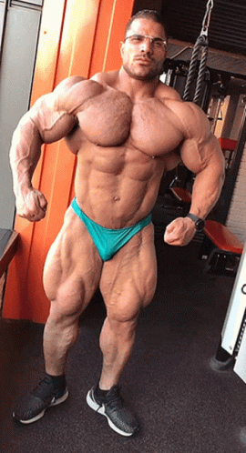 Muscular Man With Glasses In Green Underwear Posing In Gym GIF