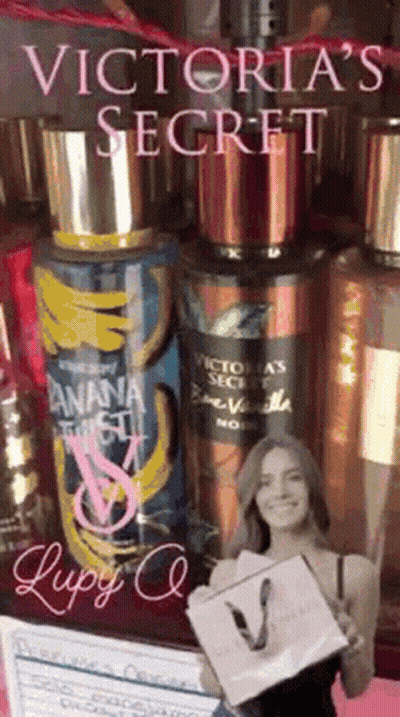 A Victoria 'S Secret Advertisement With A Woman Holding A Shopping Bag GIF