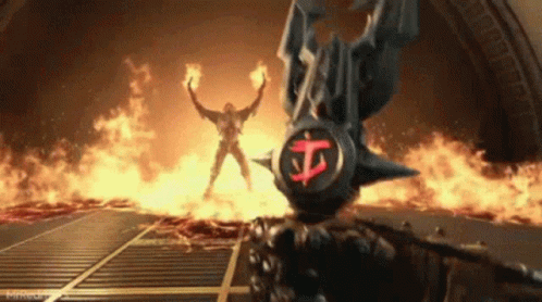 A Video Game Character Is Holding A Sword In Front Of A Statue Of A Demon . GIF