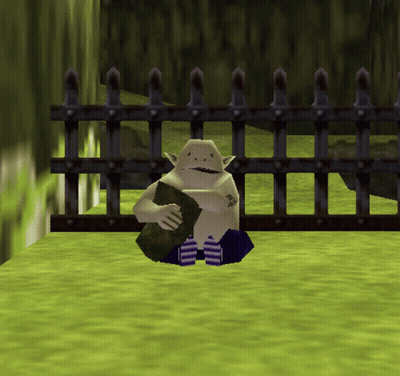 A Video Game Character Is Sitting In Front Of A Fence Holding A Rock GIF