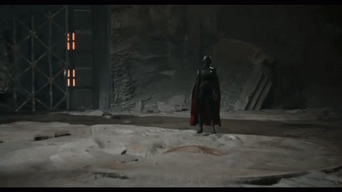 A Video Game Character Is Standing In A Dark Room And Talking To Col Kesis GIF