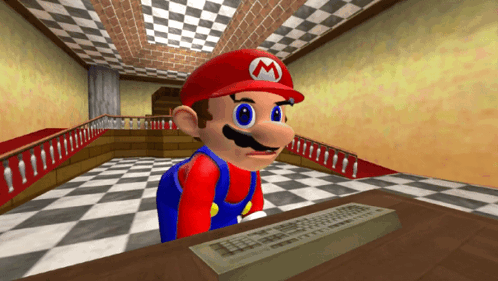 A Video Game Character Named Mario Is Sitting At A Desk GIF