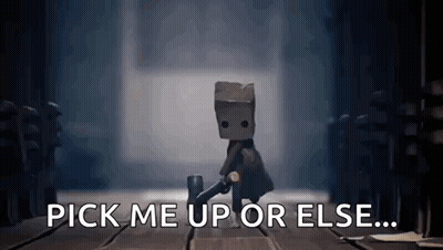 A Video Game Character With A Bag On His Head Is Standing On A Wooden Floor And Says `` Pick Me Up Or Else ... '' GIF