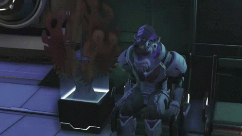 A Video Game Character With A Purple Head And A Beard Is Standing In A Room GIF