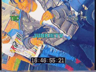 A Video Of A Man Reading A Magazine Says Junkietv At The Top GIF