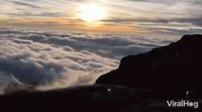 A Video Of A Mountain Covered In Clouds With The Words Viralhog On The Bottom Right GIF
