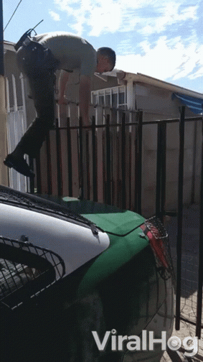 A Video Of A Police Officer Jumping Over A Fence Has The Word Viralhog On The Bottom GIF