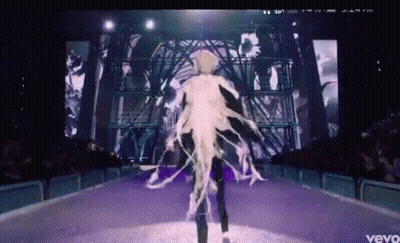 A Video Of A Woman Walking Down A Runway With The Word Vevo At The Bottom GIF