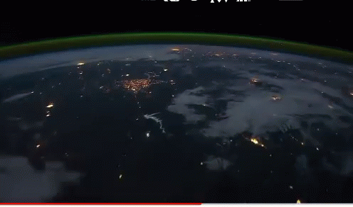A Video Of The Earth At Night With A Red Arrow Pointing To The Left GIF