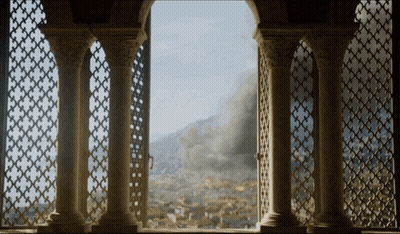 A View Of A City From A Balcony With Columns GIF