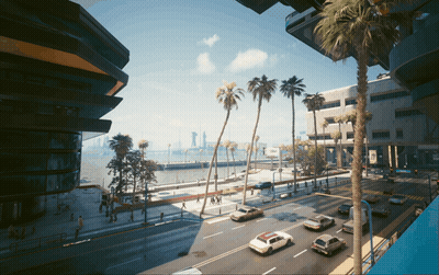 A View Of A City Street With Palm Trees And Buildings GIF