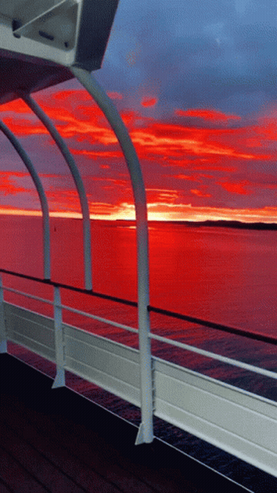 A View Of A Sunset From A Boat Deck GIF